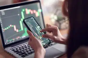 Woman Analysing Crypto Chart On Phone